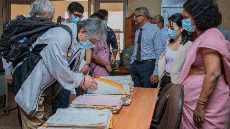 A professional archival conservator evaluating a heavily water-damaged and warped open book on a clean workspace. Superimposed to the right is an informational list detailing standard document drying and recovery techniques, including vacuum freeze-drying, thermal drying, desiccant air drying, hand dry cleaning, and digital reproduction methods.